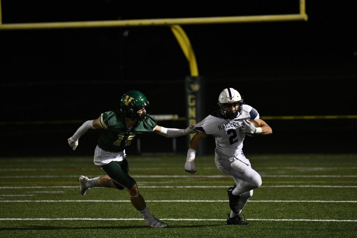 Sam Grew runs the ball against New Bedford Voc.