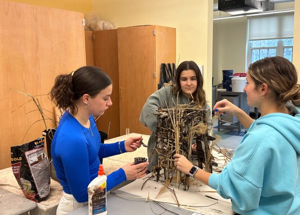 Audrey Sperling, Sadee Arruda, and Karis Botelho (from left to right) all work on creating a model of the wind phone to be built. The real wind phone will be about 7 feet tall and 4 feet wide.